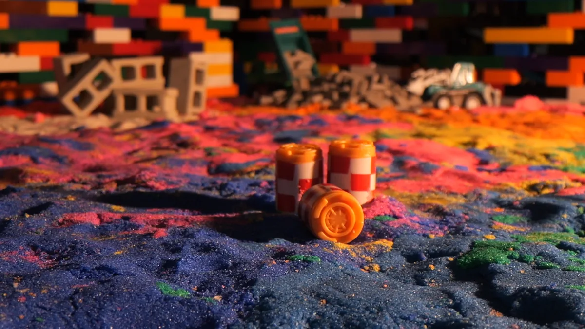 Tiny barrels resting on a field of colored sand